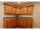 Kitchen features wood cabinets with granite countertops, offering plenty of storage and prep space at 2449 Kingstree Pl, The Villages, FL 32162