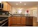 Modern kitchen with granite countertops offers an open view of the living and dining areas at 2449 Kingstree Pl, The Villages, FL 32162