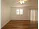Bright living room featuring wood floors, neutral tones, and large sliding glass doors at 2449 Kingstree Pl, The Villages, FL 32162
