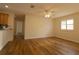 Bright, open living room featuring hardwood floors, plantation shutters, and a ceiling fan at 2449 Kingstree Pl, The Villages, FL 32162