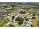 Community aerial view showcases houses nestled amongst lakes and lush greenery in a serene setting at 24802 Pine Hl, Leesburg, FL 34748