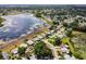 Aerial perspective showcasing homes near a tranquil lake, with lush greenery and open spaces at 24802 Pine Hl, Leesburg, FL 34748