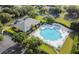 Aerial view of a large pool and clubhouse, surrounded by lounge chairs and greenery, in a neighborhood setting at 24802 Pine Hl, Leesburg, FL 34748