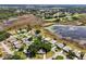 Wide aerial perspective showing a serene community, tranquil lake, and lush natural surroundings at 24802 Pine Hl, Leesburg, FL 34748