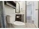 Cozy bathroom featuring a toilet, vanity with a sink, a large mirror and a neutral color scheme at 24802 Pine Hl, Leesburg, FL 34748