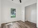 Bright bedroom features hardwood floors, a window with natural light and a closet space at 24802 Pine Hl, Leesburg, FL 34748
