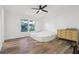 Bright bedroom with natural light, wood-look flooring, and dresser at 24802 Pine Hl, Leesburg, FL 34748