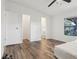 Bright bedroom with wood-look flooring, closet, and en-suite bathroom at 24802 Pine Hl, Leesburg, FL 34748