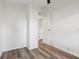 Empty bedroom featuring wood-look flooring and white walls at 24802 Pine Hl, Leesburg, FL 34748