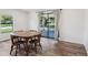 Dining room featuring wood-look flooring and view of the screened in patio at 24802 Pine Hl, Leesburg, FL 34748