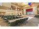 Spacious event space showcasing rows of tables, a stage with red curtains, and high ceilings with chandeliers at 24802 Pine Hl, Leesburg, FL 34748