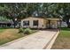 Charming single-story home with a well-manicured front yard, and a covered parking area at 24802 Pine Hl, Leesburg, FL 34748
