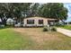 Charming single-story home features a screened-in porch and a well-maintained front yard with mature landscaping at 24802 Pine Hl, Leesburg, FL 34748