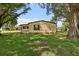 Charming single-story home showcasing a well-maintained lawn and mature trees, providing a serene outdoor space at 24802 Pine Hl, Leesburg, FL 34748
