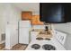 Efficient kitchen with white appliances and wood-look flooring for easy maintenance at 24802 Pine Hl, Leesburg, FL 34748
