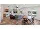 Open-concept living area features a kitchen, built-in shelving, dining area, and a covered sofa at 24802 Pine Hl, Leesburg, FL 34748
