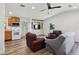Bright living room with wood-look flooring, ceiling fan, and built in entertainment center at 24802 Pine Hl, Leesburg, FL 34748