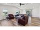 Inviting living room with lots of light, wood-look floors, and neutral color palette at 24802 Pine Hl, Leesburg, FL 34748