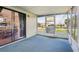 Enclosed patio with sliding glass doors and neighborhood view, providing a transition between indoor and outdoor living at 24802 Pine Hl, Leesburg, FL 34748