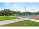 Well-maintained tennis courts in a lush community setting, perfect for recreational activities and enjoyment at 24802 Pine Hl, Leesburg, FL 34748