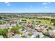 Aerial view of the home within the community with a golf course in the background at 2669 Halsey Ter, The Villages, FL 32162