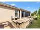 Comfortable outdoor area has brick pavers and seating, and access to screened in patio at 2669 Halsey Ter, The Villages, FL 32162