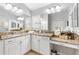 Bathroom features dual sinks, granite countertops, vanity area, tile flooring, and bright lighting at 2669 Halsey Ter, The Villages, FL 32162