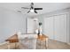 Bright bedroom features a large window, ceiling fan, and a double closet at 2669 Halsey Ter, The Villages, FL 32162