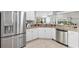 Bright kitchen with stainless steel appliances and granite countertops, with an open floor plan at 2669 Halsey Ter, The Villages, FL 32162