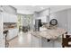 Well-lit kitchen features white cabinets, granite countertops, stainless steel appliances, and an adjacent dining area at 2669 Halsey Ter, The Villages, FL 32162