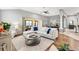 Comfortable sectional sofa with views to an outdoor living space and a formal dining area at 2669 Halsey Ter, The Villages, FL 32162