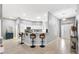 Bright living room featuring an island with bar seating and an entryway with a decorative glass front door at 2669 Halsey Ter, The Villages, FL 32162