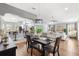 Open concept living space featuring hardwood floors, and views of the kitchen and dining area at 2669 Halsey Ter, The Villages, FL 32162