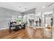 Open concept living space featuring hardwood floors, and views of the kitchen and dining area at 2669 Halsey Ter, The Villages, FL 32162