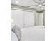 Comfortable bedroom features a ceiling fan, natural light and an entrance to the ensuite bathroom at 2669 Halsey Ter, The Villages, FL 32162