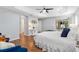 View of main bedroom featuring a tray ceiling, hardwood floors, and sliding doors to the lanai at 2669 Halsey Ter, The Villages, FL 32162