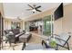 Relaxing outdoor patio features comfortable seating and views through sliding glass doors at 2669 Halsey Ter, The Villages, FL 32162