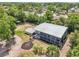 Aerial view of the expansive property, showcasing the building, outdoor patio area, and lush landscaping at 300 Carol Ann Dr, Edgewater, FL 32132