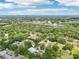 Aerial view of the metal roofed property on a treed lot with marker at 300 Carol Ann Dr, Edgewater, FL 32132