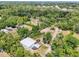 Expansive aerial view captures the metal roofed building, the vast landscape, and other surrounding buildings and residences at 300 Carol Ann Dr, Edgewater, FL 32132