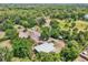 Drone view shows a metal roofed building on a large lot interspersed with other homes and a scenic distant view at 300 Carol Ann Dr, Edgewater, FL 32132