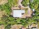 Aerial view showcases the metal roofed building amidst lush greenery and highlights the property's spacious surroundings at 300 Carol Ann Dr, Edgewater, FL 32132