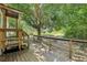 Large wooden porch area with backyard view of a lush, grassy yard at 300 Carol Ann Dr, Edgewater, FL 32132