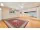 Basement features hardwood floors, windows for natural light, and a large decorative area rug at 300 Carol Ann Dr, Edgewater, FL 32132