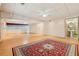 Open basement design with hardwood floors, area rug, and direct access to a bathroom with pedestal sink at 300 Carol Ann Dr, Edgewater, FL 32132