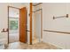 Neutral bathroom features a walk-in shower, open doorway and a tiled floor at 300 Carol Ann Dr, Edgewater, FL 32132