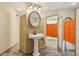 Fun bathroom featuring saloon doors and a pedestal sink under decorative lighting at 300 Carol Ann Dr, Edgewater, FL 32132