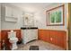 Well-lit bathroom featuring paneled walls, a modern vanity, and ample storage space at 300 Carol Ann Dr, Edgewater, FL 32132