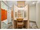 Bathroom vanity area with mirrors and lighting, adjacent to a shower area behind saloon doors at 300 Carol Ann Dr, Edgewater, FL 32132