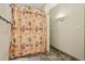 Bright bathroom featuring a shower with patterned curtain and open shelving at 300 Carol Ann Dr, Edgewater, FL 32132